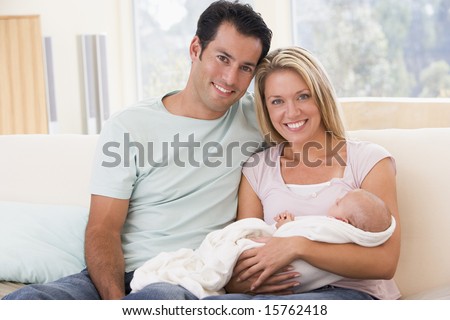 stock photo : Couple in living room with baby smiling