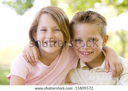 Brother And Sister Sitting Outdoors Smiling Stock Photo 15809572 