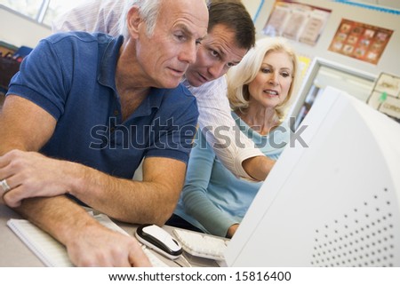 Male and female mature students working together on a computer