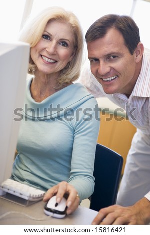 Mature female student learning computer skills
