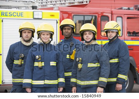 Portrait of a group of firefighters by a fire engine