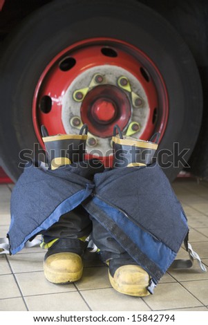 Firefighter\'s boots and trousers in a fire station