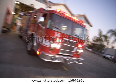 Fire engine rushing out of a fire station