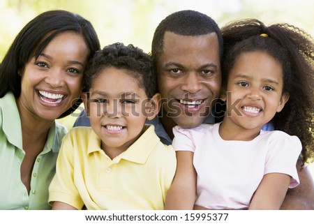 Family outdoors smiling