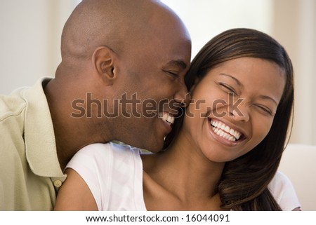 stock photo : Couple in living room smiling