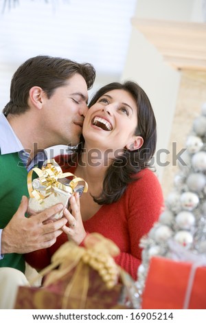 stock photo : Husband Surprising Wife With Christmas Present