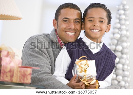 Father And Son Hugging,Holding Christmas Gift