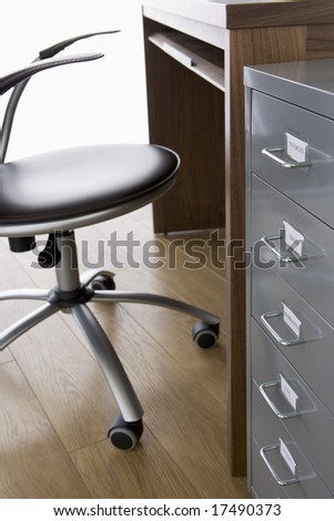 Empty Chair And Desk With Filing Cabinet