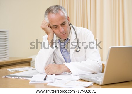 Doctor exhausted at desk