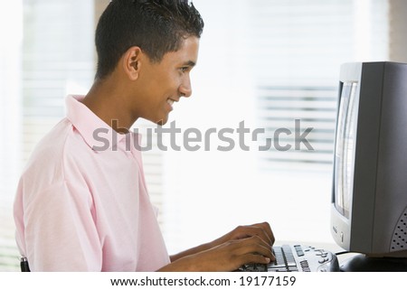 Teenage Boy Sitting On A Computer