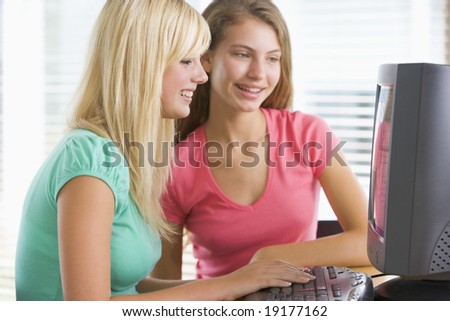Teenage Girls Sitting On A Computer