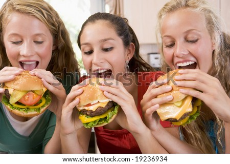 stock photo Teenagers Eating Burgers