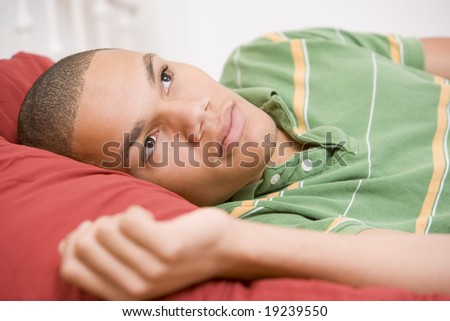 Teenage boy Lying In Bed Thinking