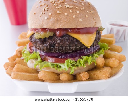 Cheese Burger In A Sesame Seed Bun With Fries
