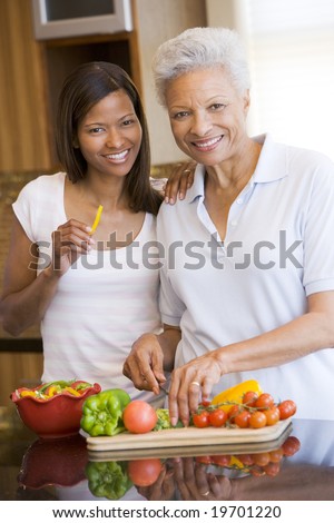 Mother And Daughter Preparing A meal,mealtime Together