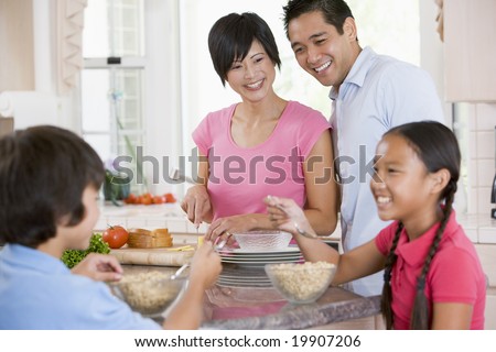 Family In The Kitchen Eating Breakfast