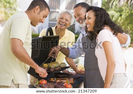 stock photo : Family Enjoying A Barbeque