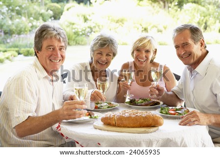 Friends Eating An Al Fresco Lunch, Holding Wine