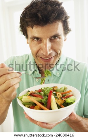 Mid Adult Man Eating A Healthy Salad