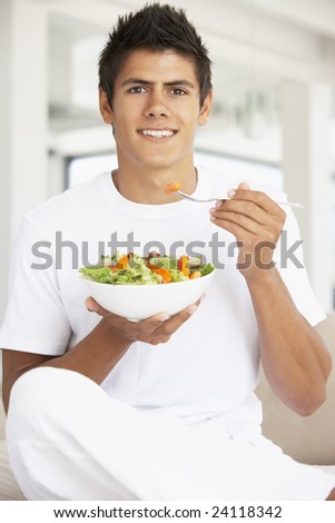 Young Man Eating A Salad