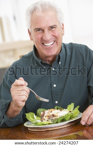 Senior Man Eating A Healthy Meal