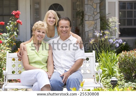 Family Sitting Outside House