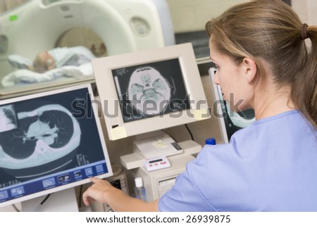Nurse With Patient As They Prepare For A Computerized Axial Tomography (CAT) Scan