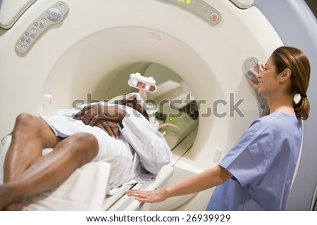 Nurse With Patient As They Prepare For A Computerized Axial Tomography (CAT) Scan