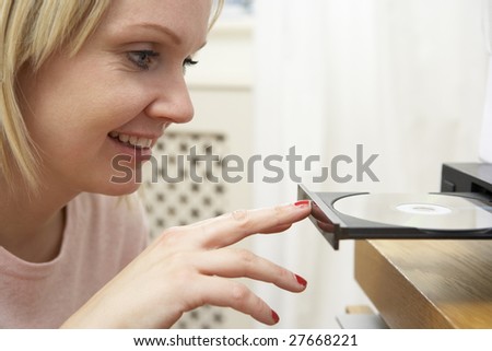 Young Woman Closing DVD Player With Finger