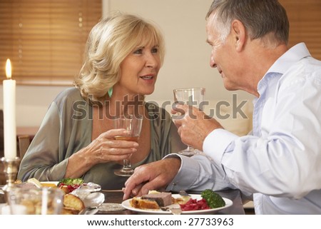 Couple Enjoying A Meal At Home Together