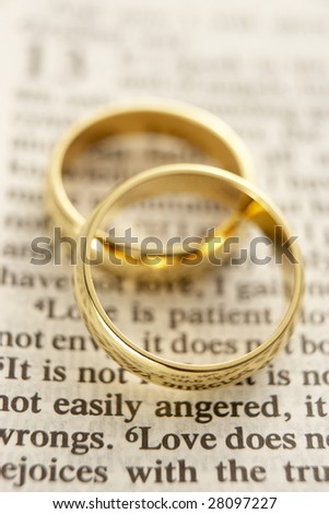 stock photo Two Wedding Rings Resting On A Bible Page