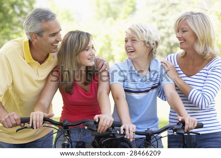 Family Cycling Through A Park