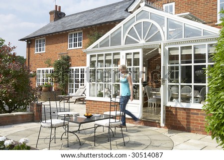 Exterior Of House With Conservatory And Patio