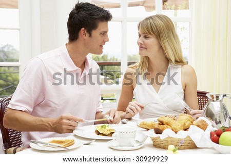 Young Couple Enjoying Hotel Breakfast