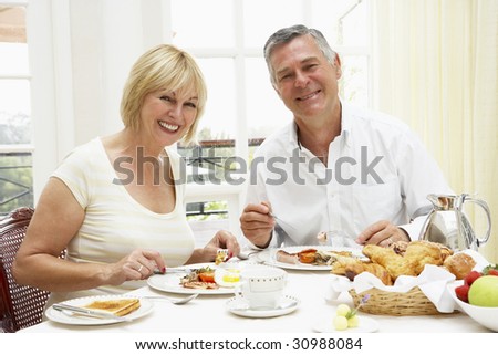Middle Aged Couple Enjoying Hotel Breakfast