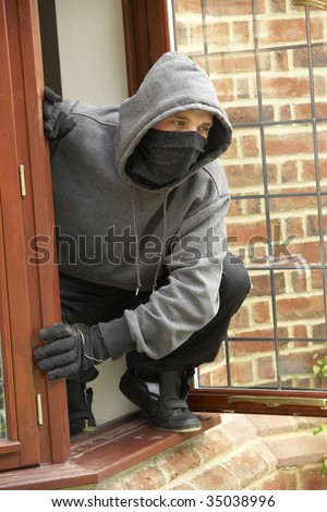 Young Man Breaking Into House