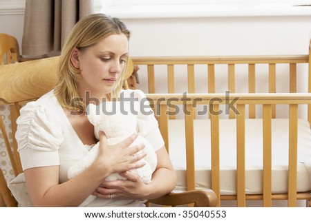 Sad Mother Sitting In Empty Nursery