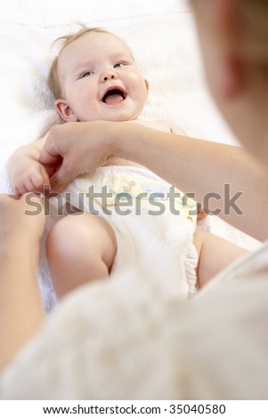 Mother Changing Baby Nappy