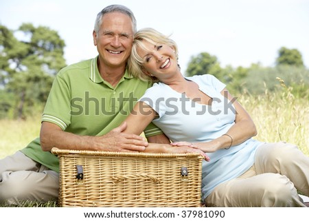 Mature couple having picnic in countryside