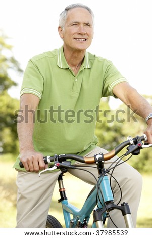 Portrait of man riding cycle in countryside