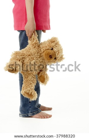 Studio Portrait of Girl Standing with Teddy Bear