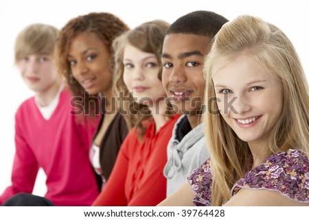 Studio Portrait Of Five Teenage Friends Standing In Line