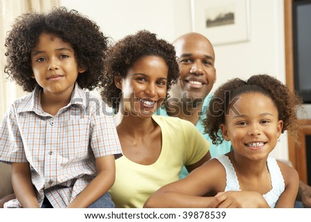 Family Relaxing At Home On Sofa