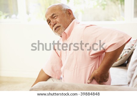 Senior Man Suffering From Back Pain At Home