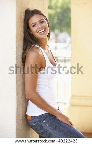 Young Woman Leaning Against Pillar