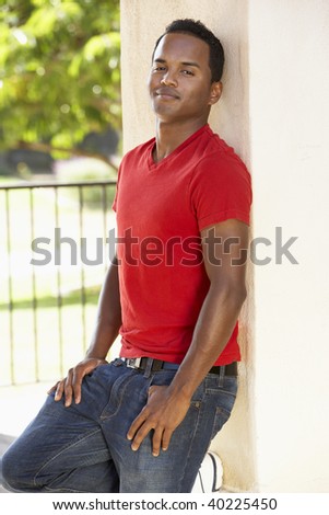 Young Man Leaning Against Pillar