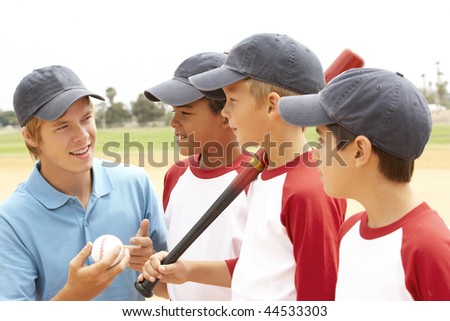 Young Boys In Baseball Team With Coach