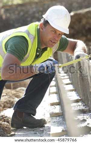 Construction Worker Laying Foundations