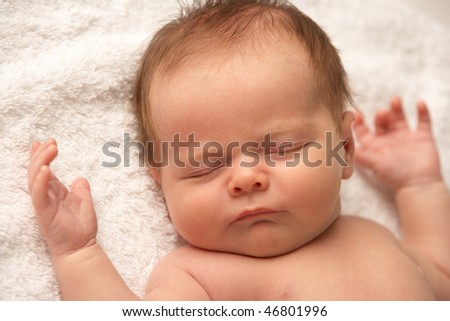 Close Up Of Baby Sleeping On Towel