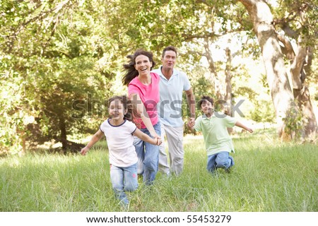 Family Enjoying Walk In Park - stock photo